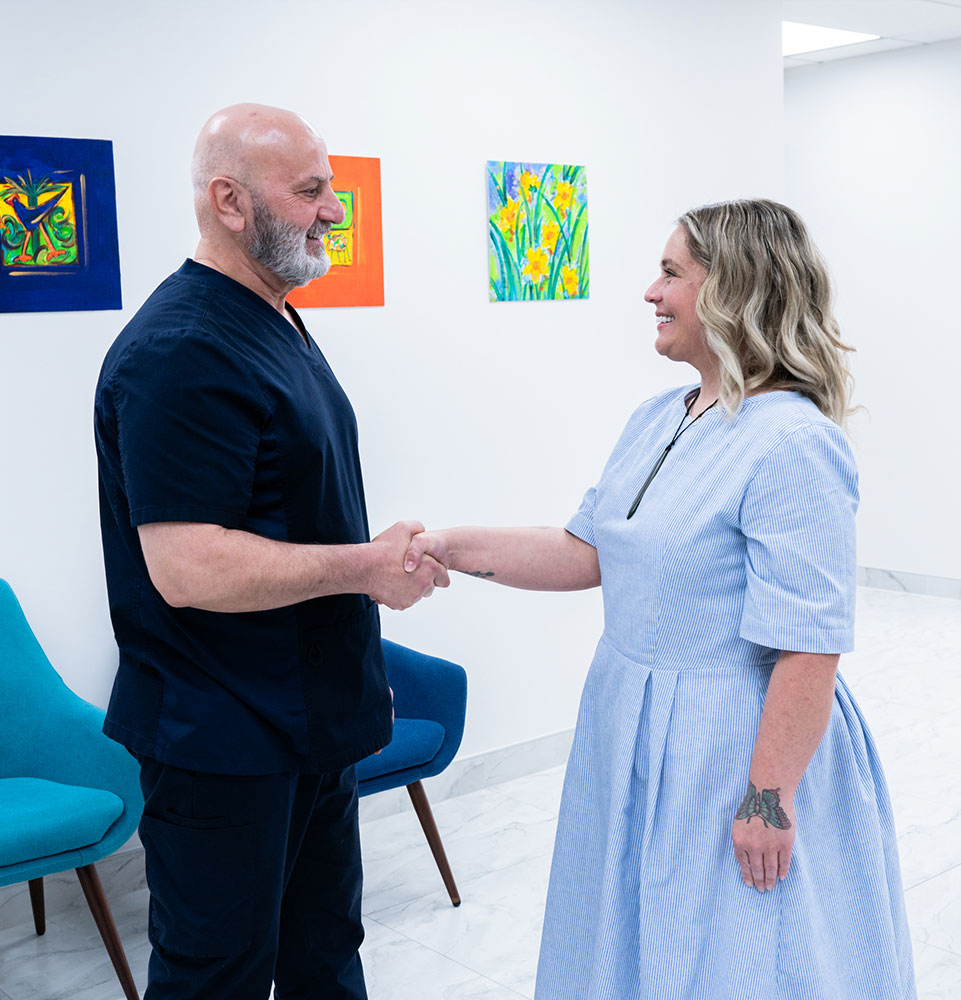 Dr. Hamid Al-Hassin shaking patiens hand