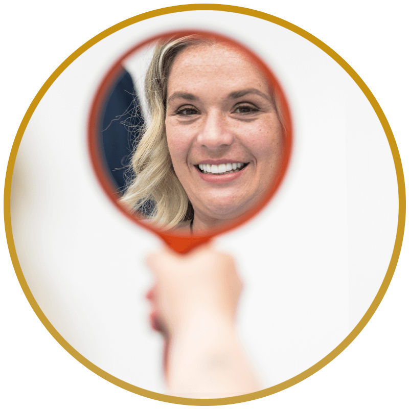 patient looking into mirror after dental implant procedure