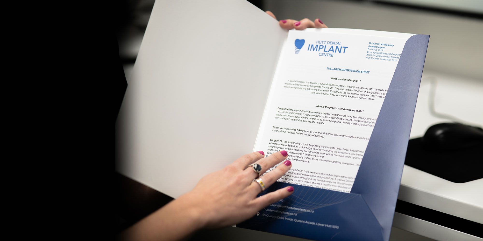 team member reading the implant warranty form